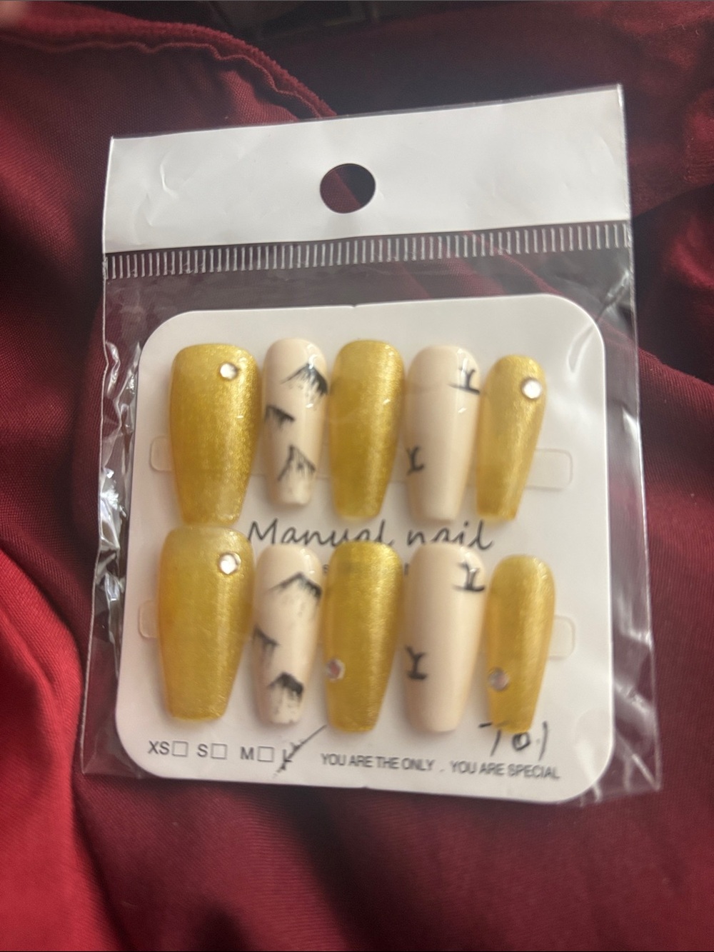 Gold and Cream Press-On Nails with Minimal Black Accent